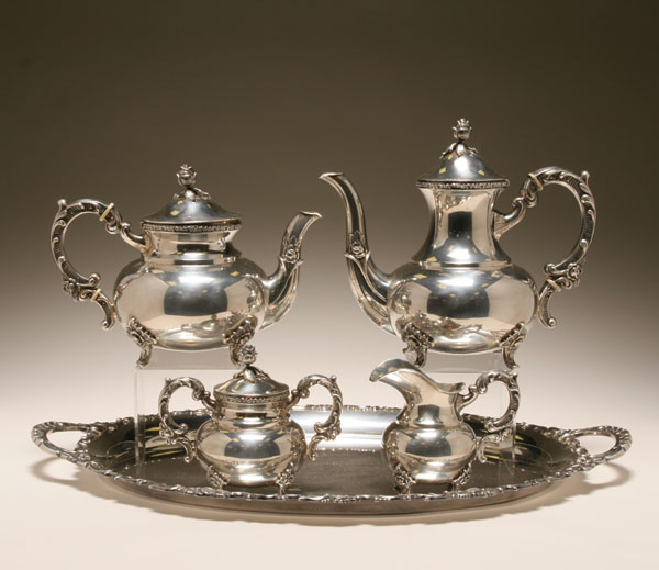 Appraisal: Ornate silverplate tea and coffee service floral designs throughout with