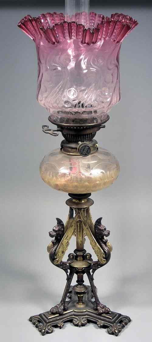 Appraisal: A late Victorian brass table oil lamp on tri-form base