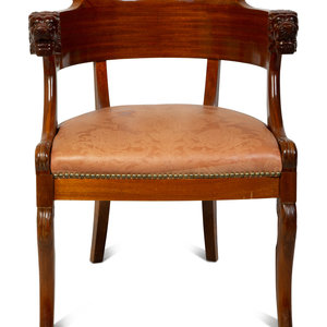 Appraisal: A Regency Style Carved Mahogany Barrel Back Armchair with Lion