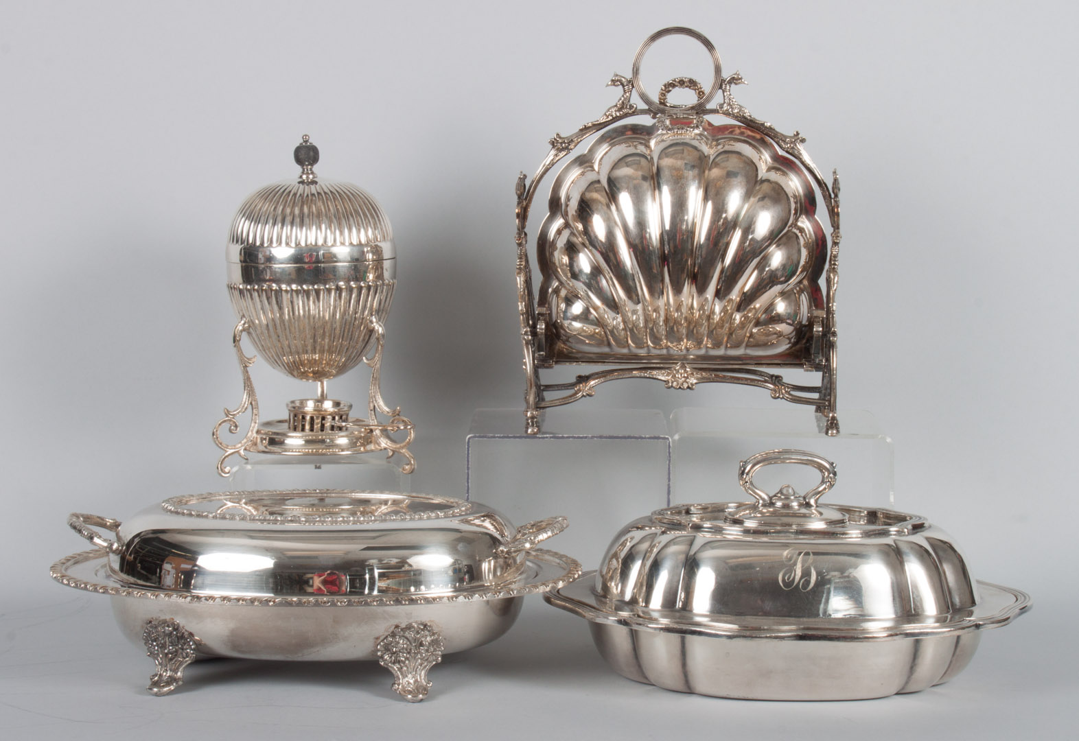 Appraisal: Four silver-plated table articles comprising two covered vegetable dishes toast