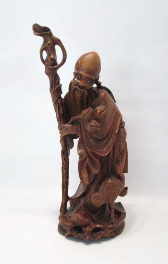 Appraisal: CHINESE CARVED HARDWOOD FIGURE of a male elder holding a