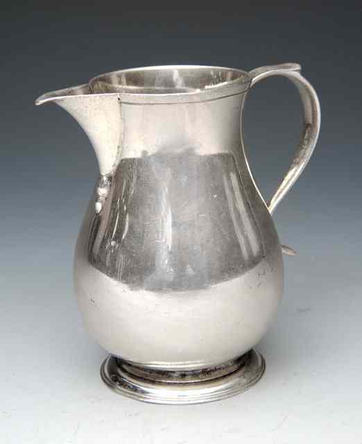 Appraisal: A GEORGIAN STYLE SMALL BALUSTER CREAM JUG with sparrow beak