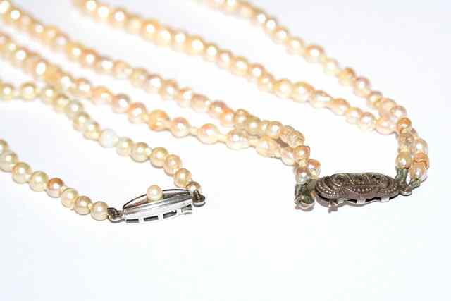 Appraisal: A DOUBLE ROW CULTURED BAROQUE PEARL NECKLACE and a further