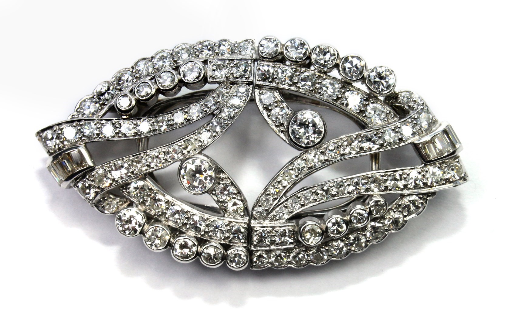 Appraisal: A diamond set double clip brooch pierced in an oval