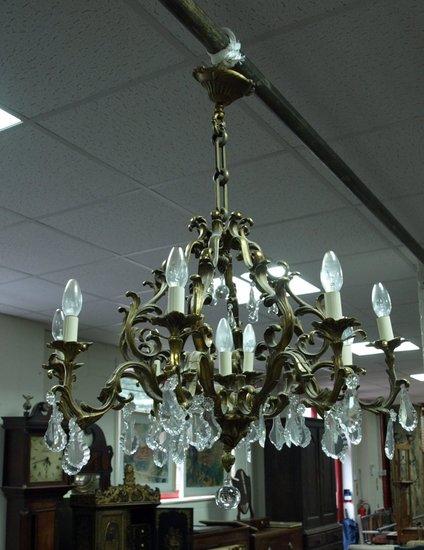 Appraisal: A gilt metal nine-light electrolier the eight scrolling supports hung