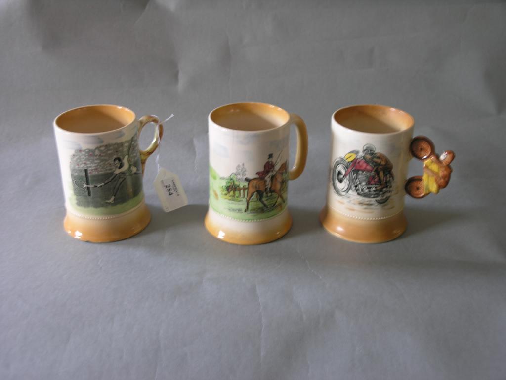 Appraisal: A group of three Arthur Wood earthenware sporting mugs tennis