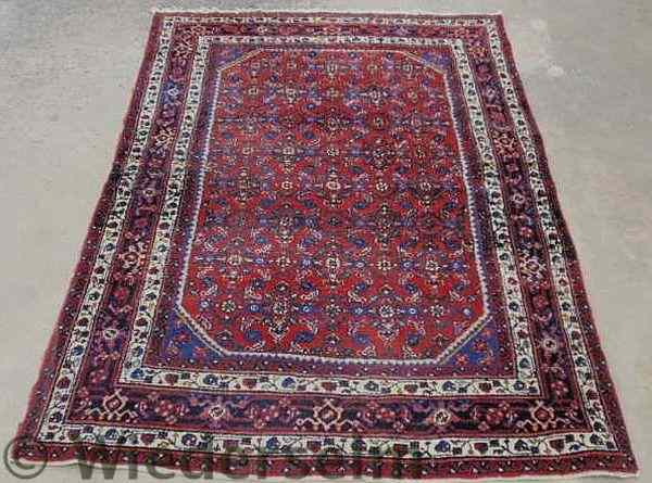 Appraisal: Persian oriental center hall carpet red field double ivory border