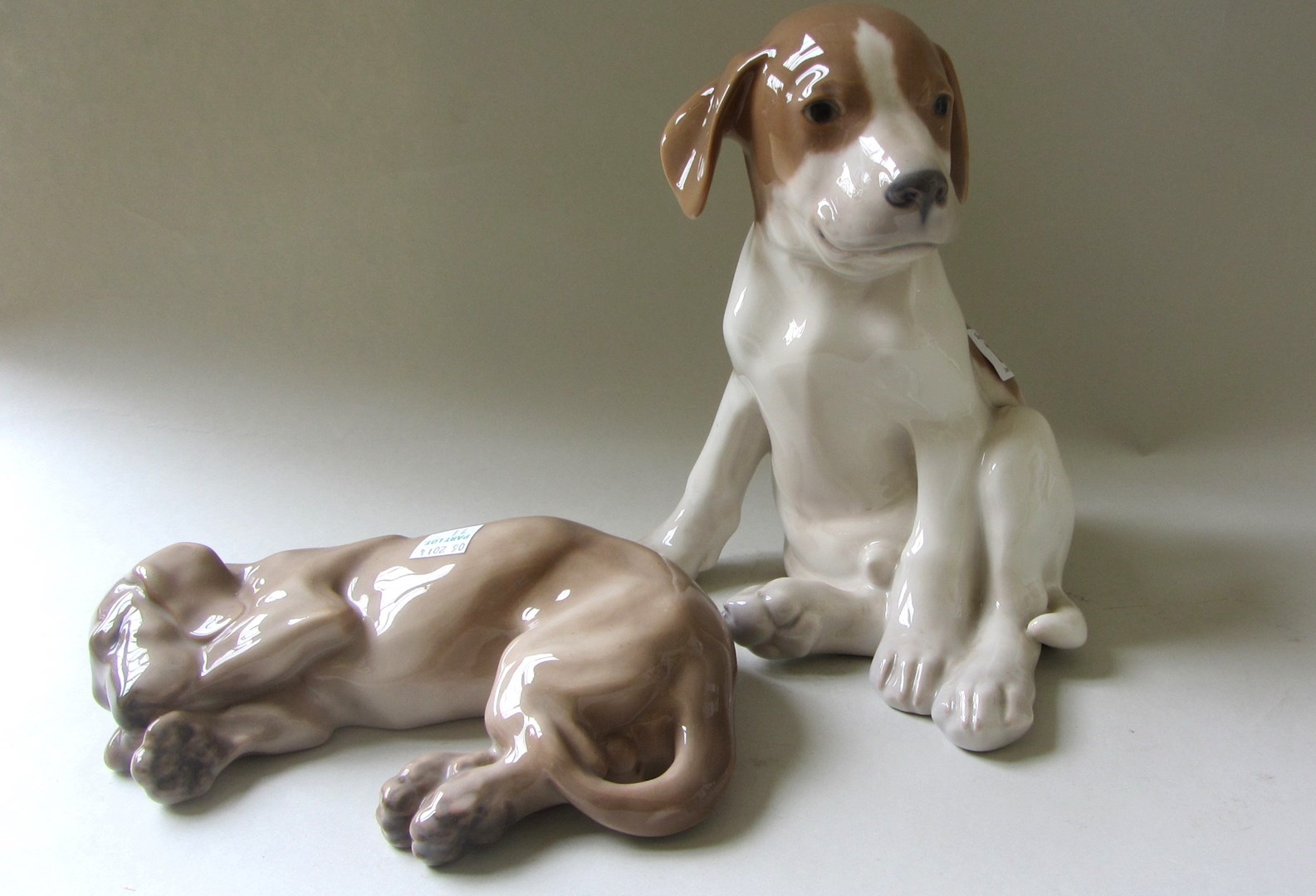 Appraisal: A Royal Copenhagen porcelain puppy in seated pose and another