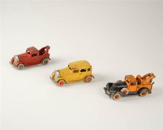 Appraisal: Three Painted Cast Iron Toy Vehicles two towing trucks and