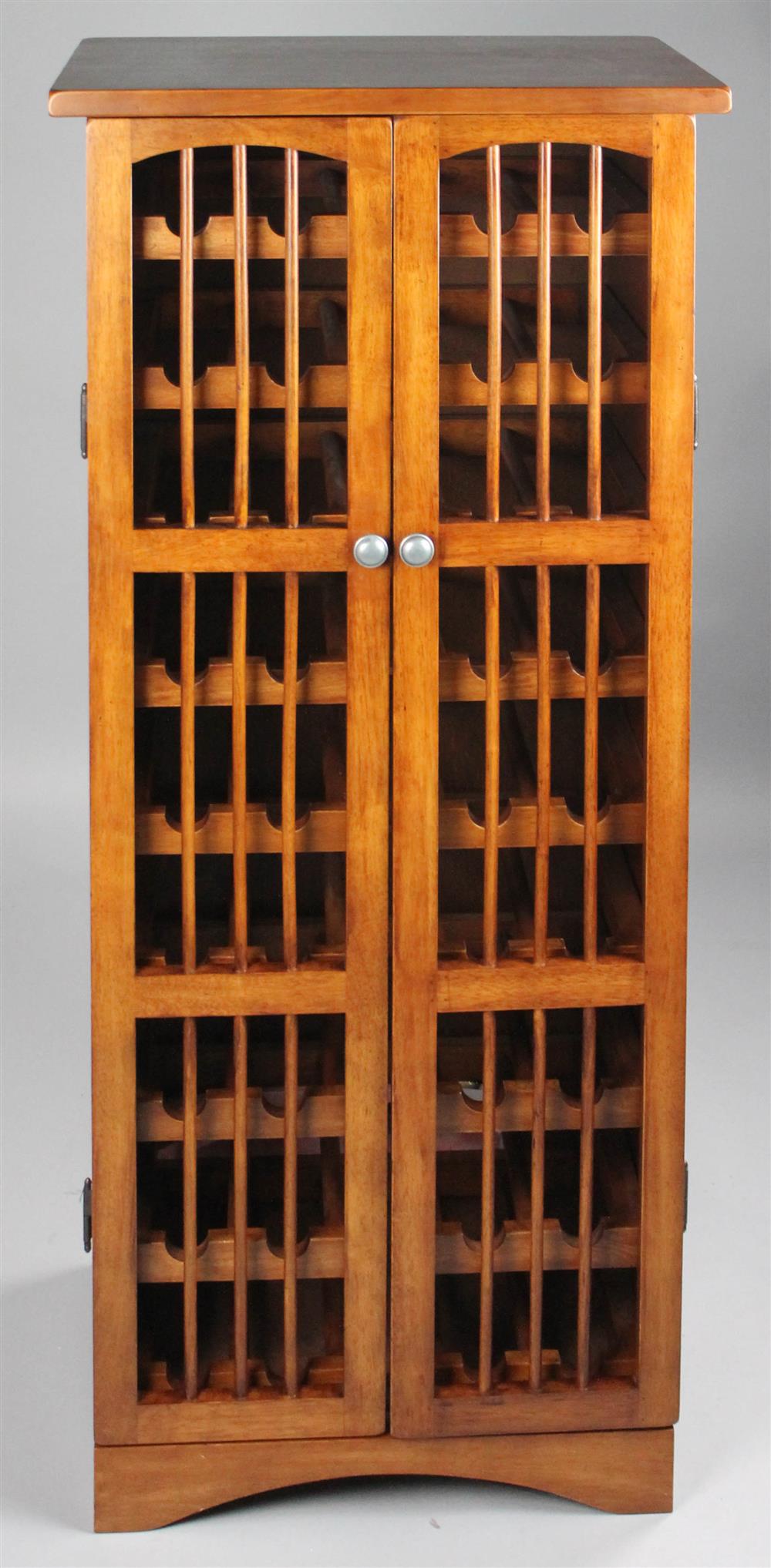 Appraisal: INDONESIAN HARDWOOD LATTICE FRONTED WINE CUPBOARD pierced double front doors