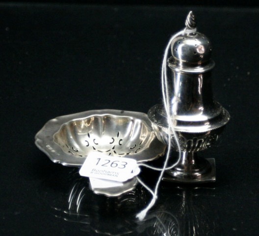 Appraisal: A baluster pepperette and a tea strainer Birmingham and respectively