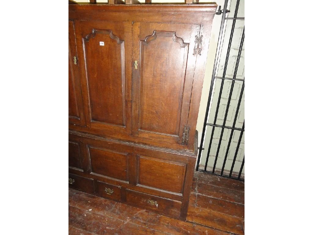 Appraisal: A Georgian oak livery cupboard the upper section enclosed by