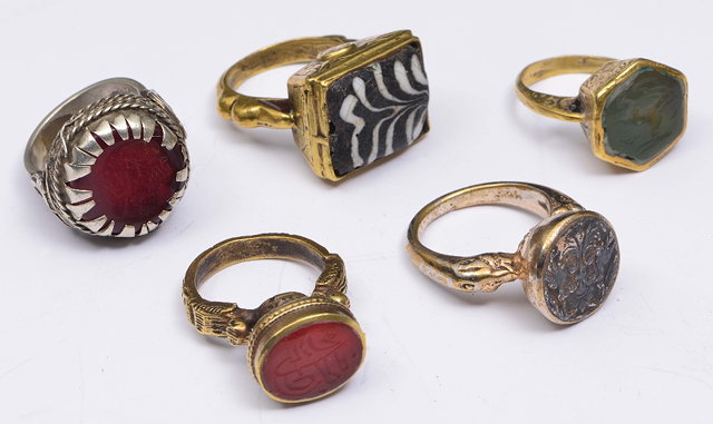 Appraisal: A COLLECTION OF FIVE GILT METAL ISLAMIC RINGS including a