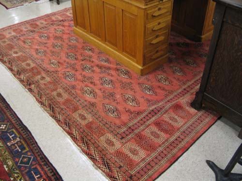 Appraisal: SEMI-ANTIQUE PERSIAN TURKOMAN CARPET red field Bokhara overall geometric gol