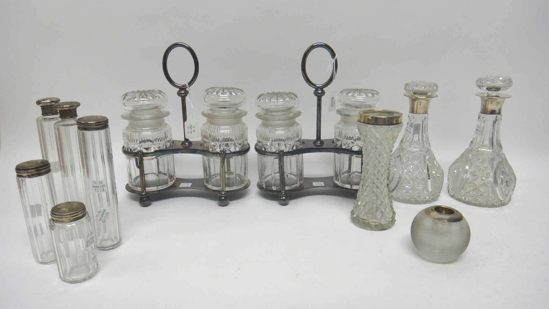 Appraisal: A pair of silver mounted faceted glass small decanters London