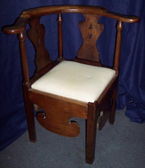 Appraisal: A George III mahogany corner commode chair with pierced splats