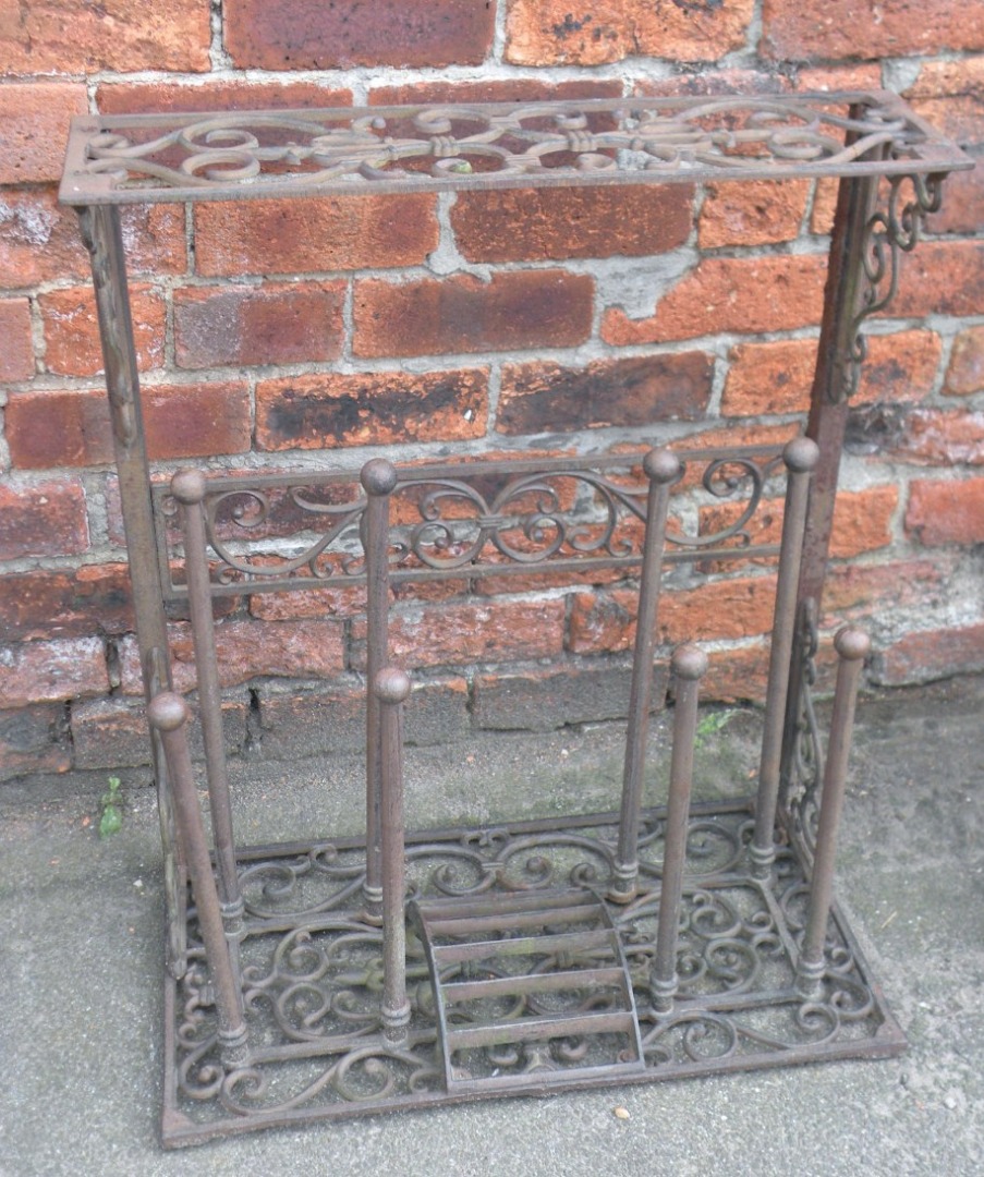 Appraisal: A cast iron umbrella and boot stand the shaped body