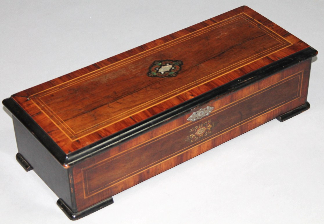 Appraisal: A thC walnut and rosewood cylinder music box the outer