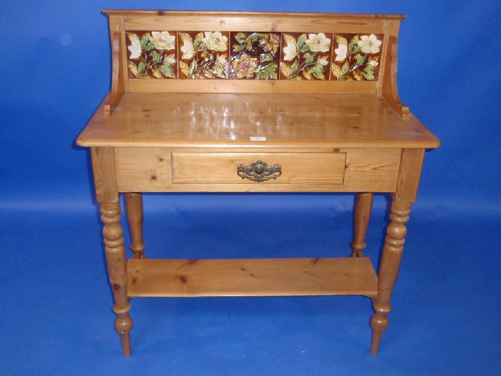 Appraisal: A Victorian stripped and waxed pine washstand with rustic tiled