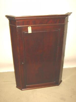 Appraisal: A GEORGE III MAHOGANY CORNER CUPBOARD the moulded and dentil