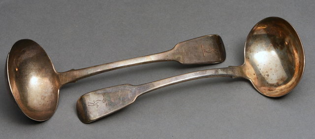 Appraisal: A PAIR OF IRISH SILVER SAUCE LADLES with engraved stags