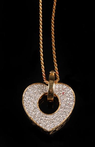 Appraisal: A diamond heart pendant the open heart pave set throughout