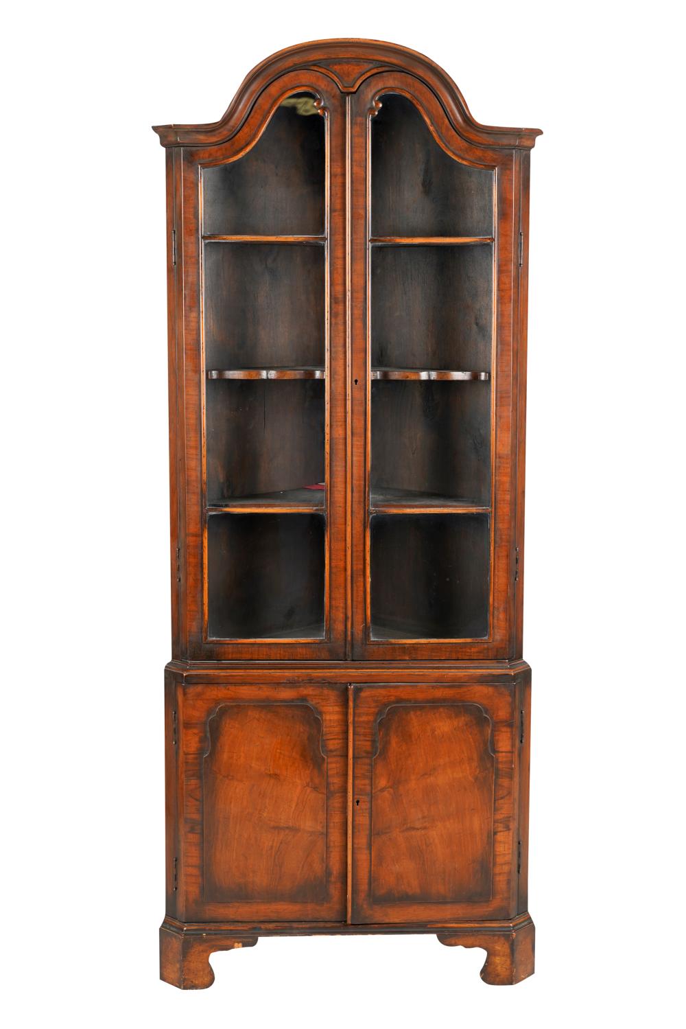 Appraisal: GEORGIAN STYLE WALNUT CORNER CABINETcomprising a pair of glazed doors