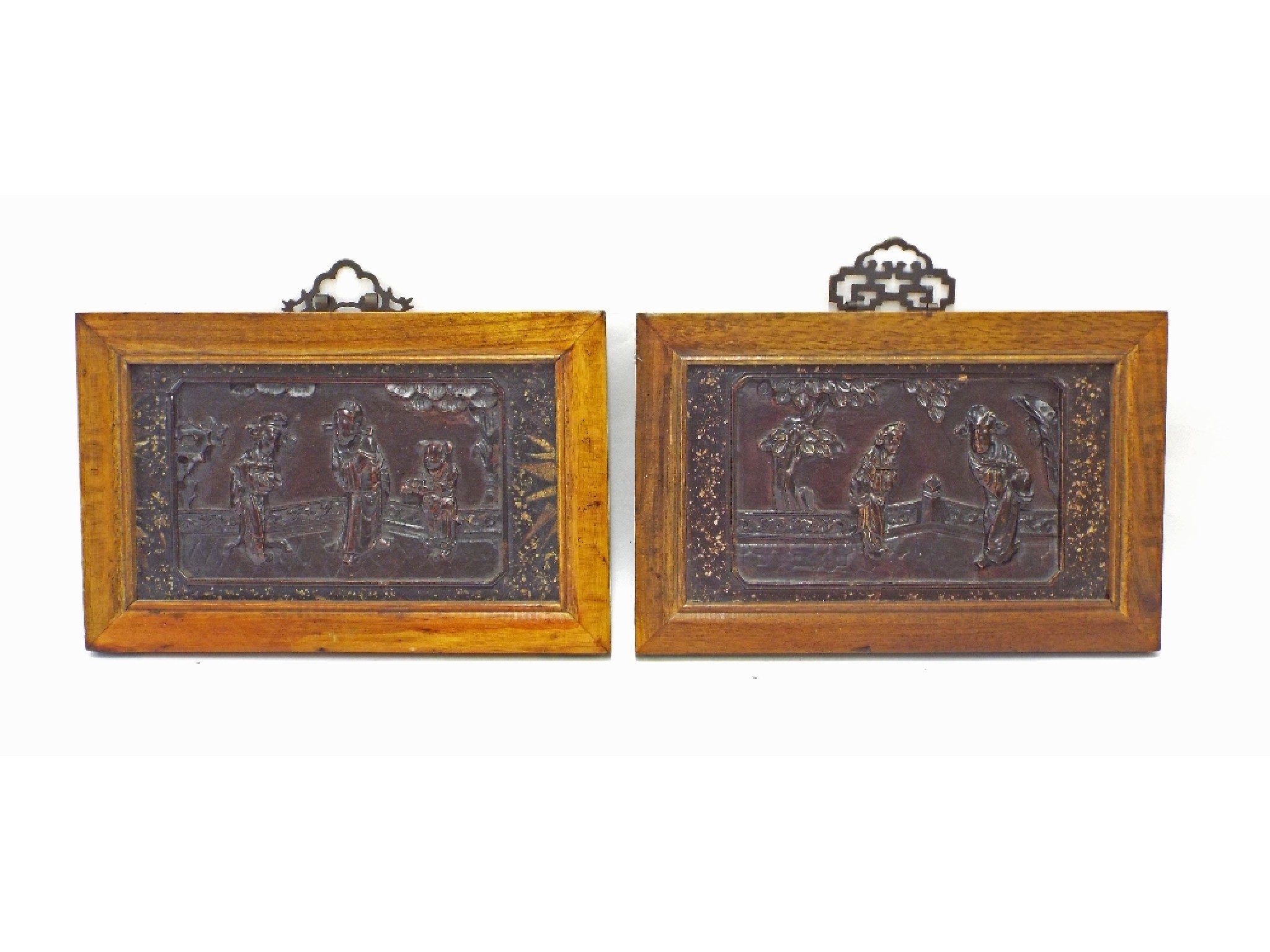 Appraisal: Pair of Japanese lacquered hardwood framed panels decorated in relief