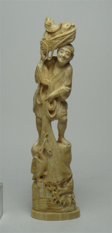 Appraisal: A Japanese ivory figure of a fisherman standing on a