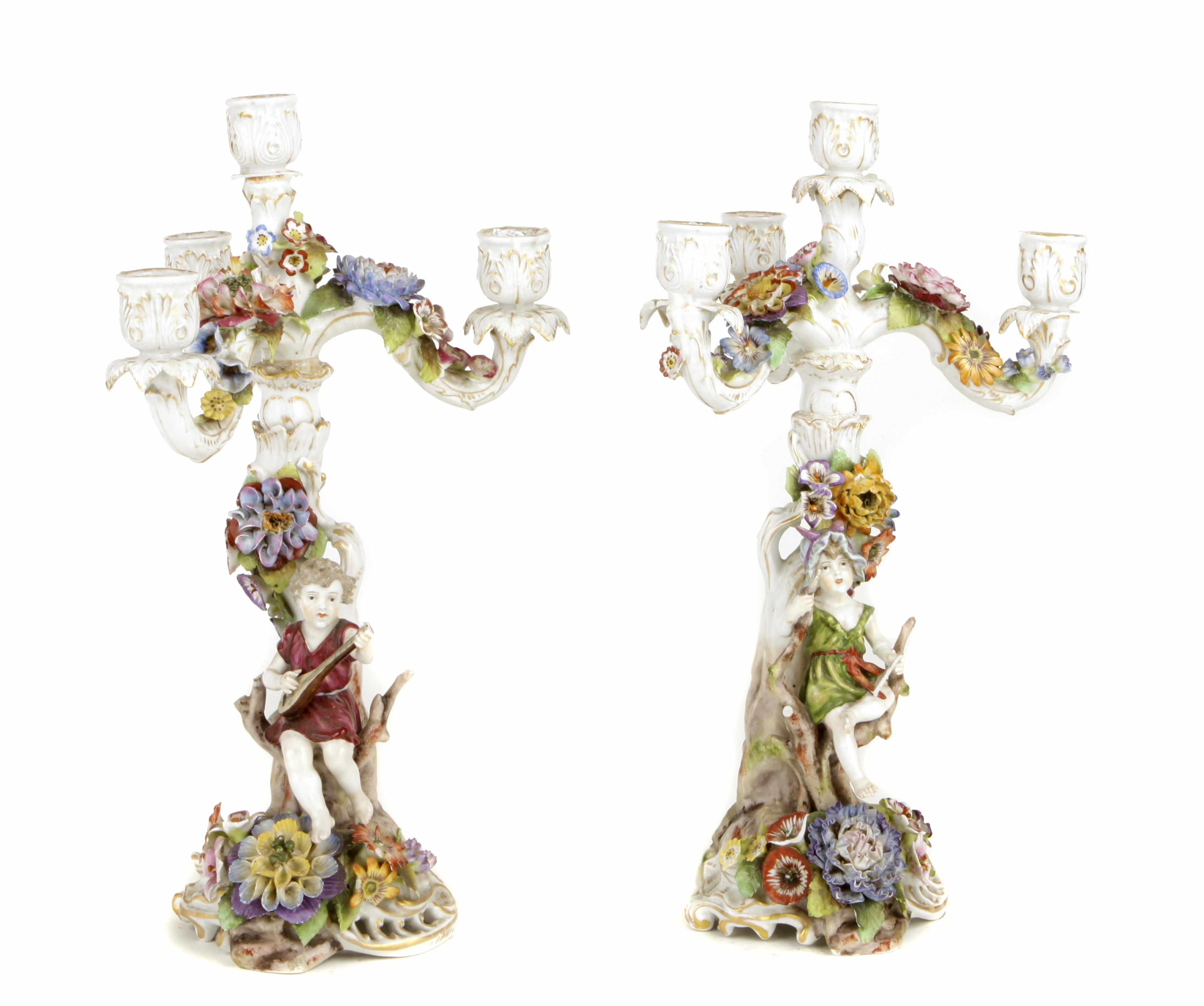 Appraisal: A pair of German porcelain four light floral encrusted figural