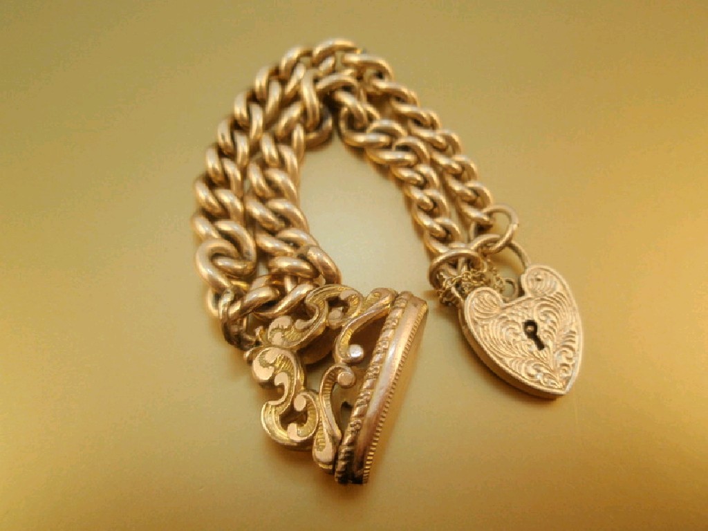 Appraisal: A ct gold curb link bracelet padlock clasp with attached