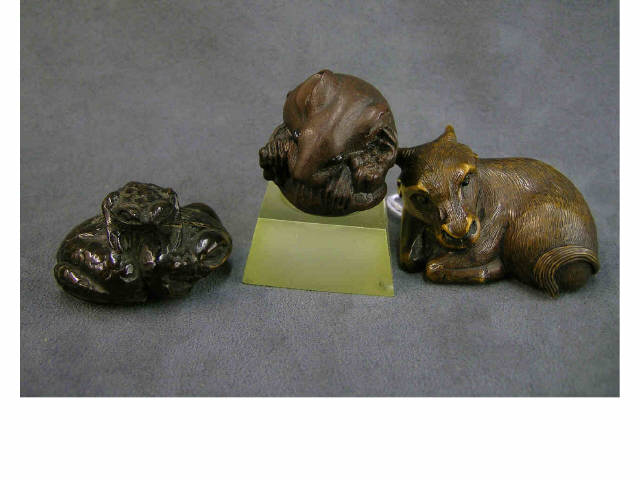 Appraisal: Three wood carved netsuke animal amphibian figures including reclining ox