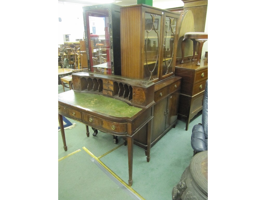 Appraisal: Reproduction leather topped desk and a reproduction display cabinet on