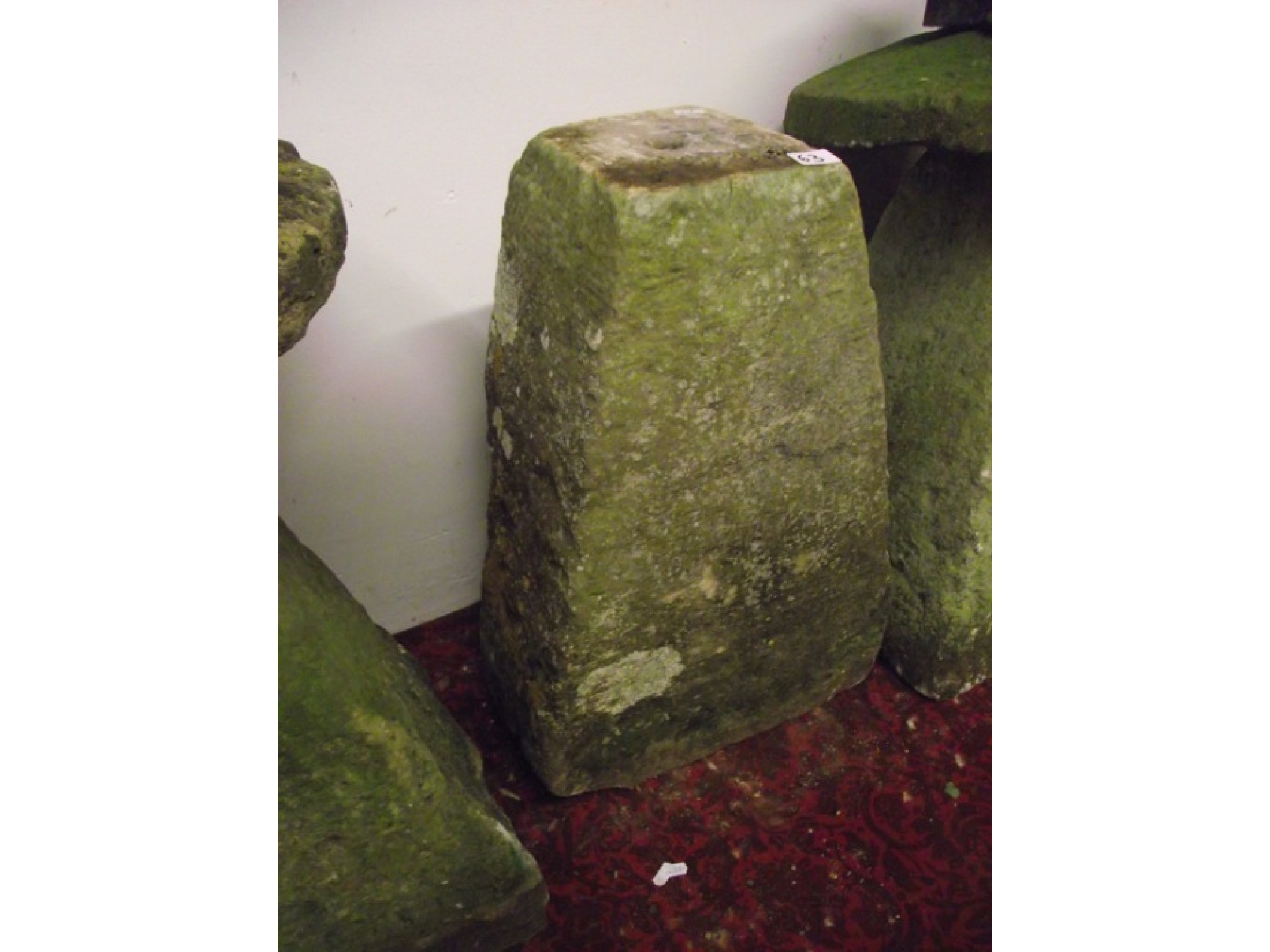 Appraisal: A weathered natural stone staddle stone base of square tapered