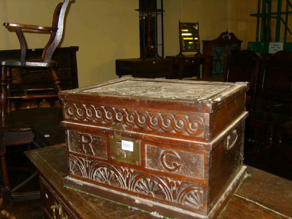 Appraisal: An antique oak table box with carved floral and geometric