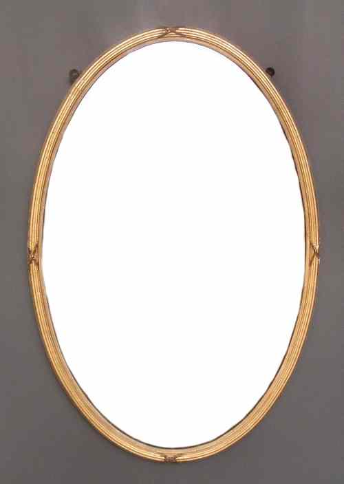 Appraisal: A gilt framed oval wall mirror with reeded and ribbon