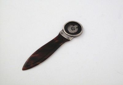 Appraisal: A silver mounted tortoiseshell book marker paperknife the circular terminal