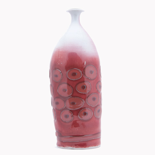 Appraisal: ADRIAN SAXE Tall porcelain bottle patterned with circles under oxblood