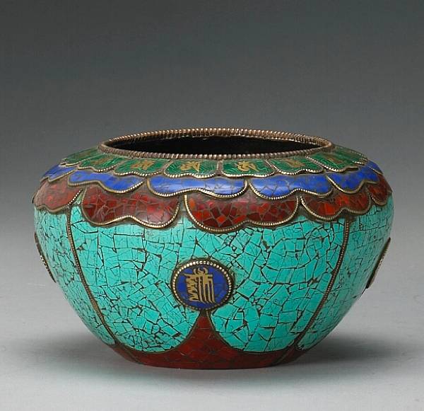 Appraisal: A Himalayan copper alloy begging bowl with colored inlay Its