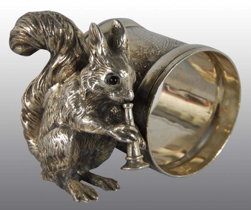 Appraisal: Squirrel Playing Horn Figural Napkin Ring Description Glass eyes No