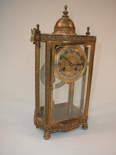 Appraisal: A gilt metal four glass table clock with Arabic numerals