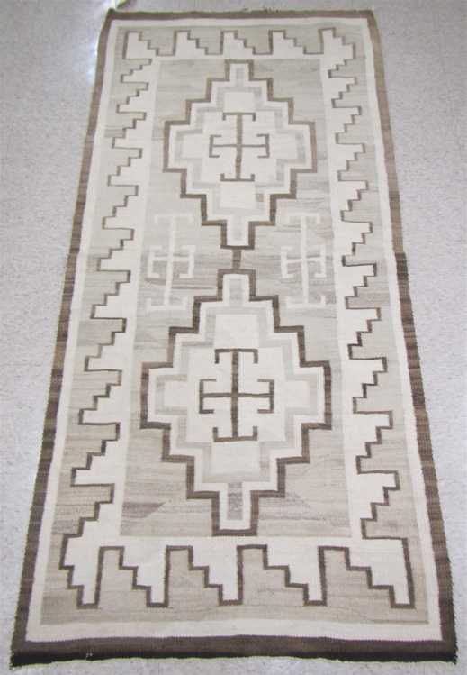 Appraisal: NAVAJO WEAVING hand woven with natural colors tan grey and