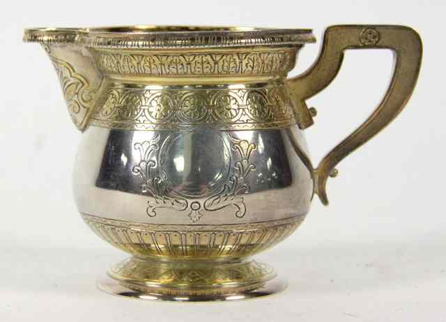 Appraisal: A Russian silver and silver gilt cream jug AO Moscow