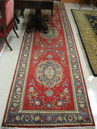 Appraisal: PERSIAN RUNNER floral and three floral medallion design on red