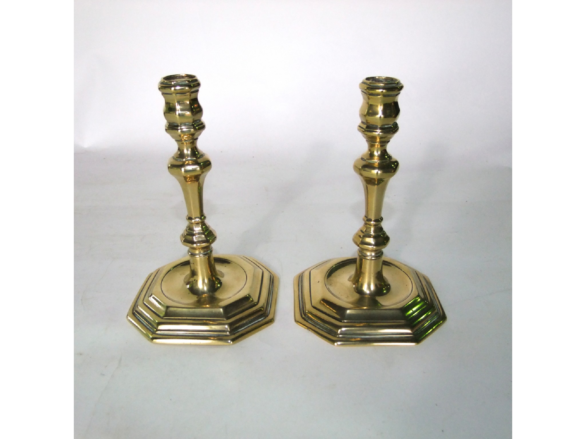 Appraisal: A pair of th century cast brass candlesticks on wide