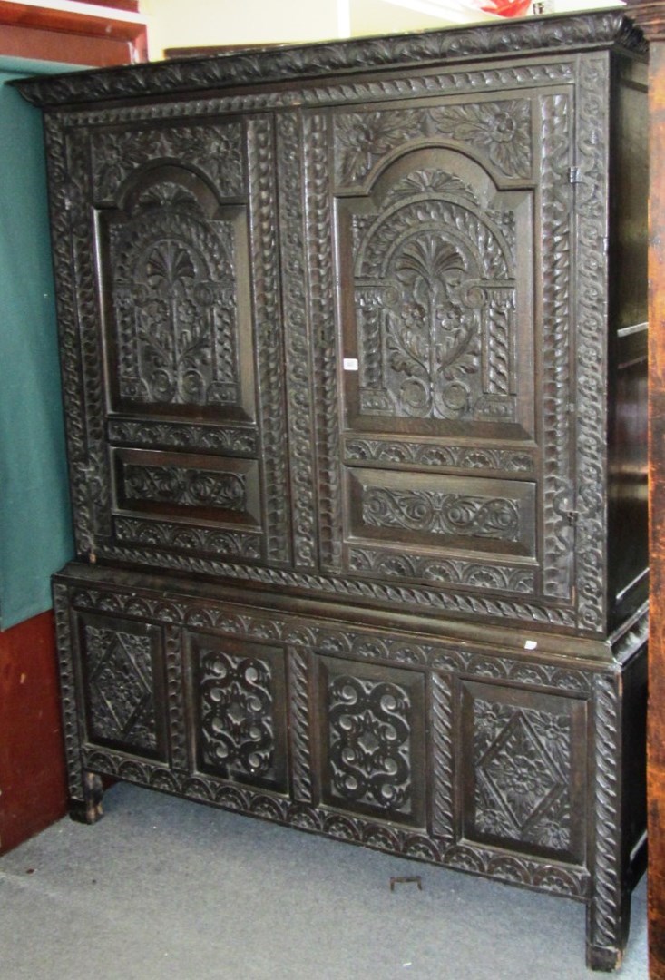 Appraisal: An th century oak later carved two door bacon cupboard