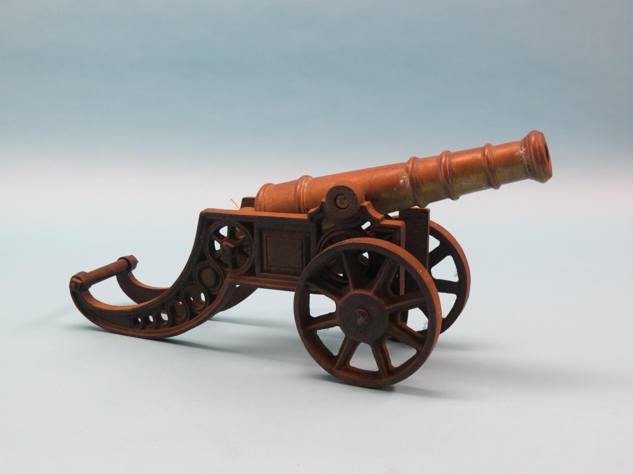 Appraisal: A bronze and cast iron cannon model bronze barrel in