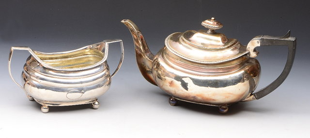 Appraisal: A GEORGIAN OVAL SHAPED SILVER TEAPOT with gadrooned edge domed