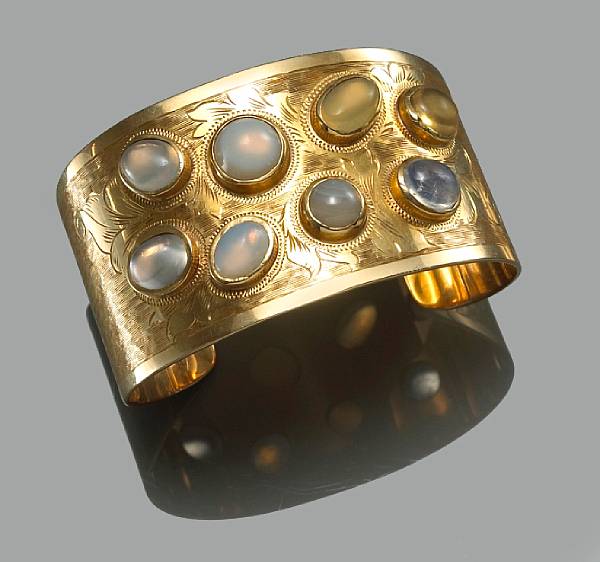 Appraisal: A multi-color moonstone and fourteen karat gold cuff bangle weighing