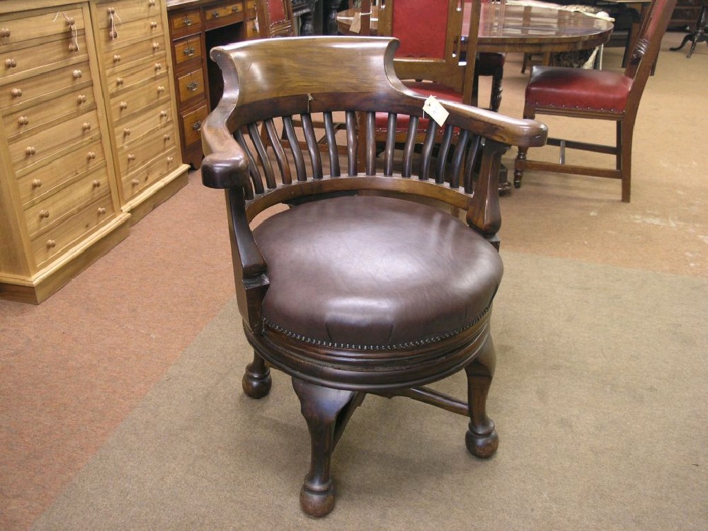 Appraisal: A late Victorian walnut revolving desk chair solid slat back